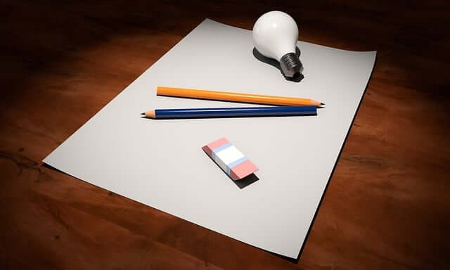 Drawing materials that include a sheet of paper, an eraser and some pencils